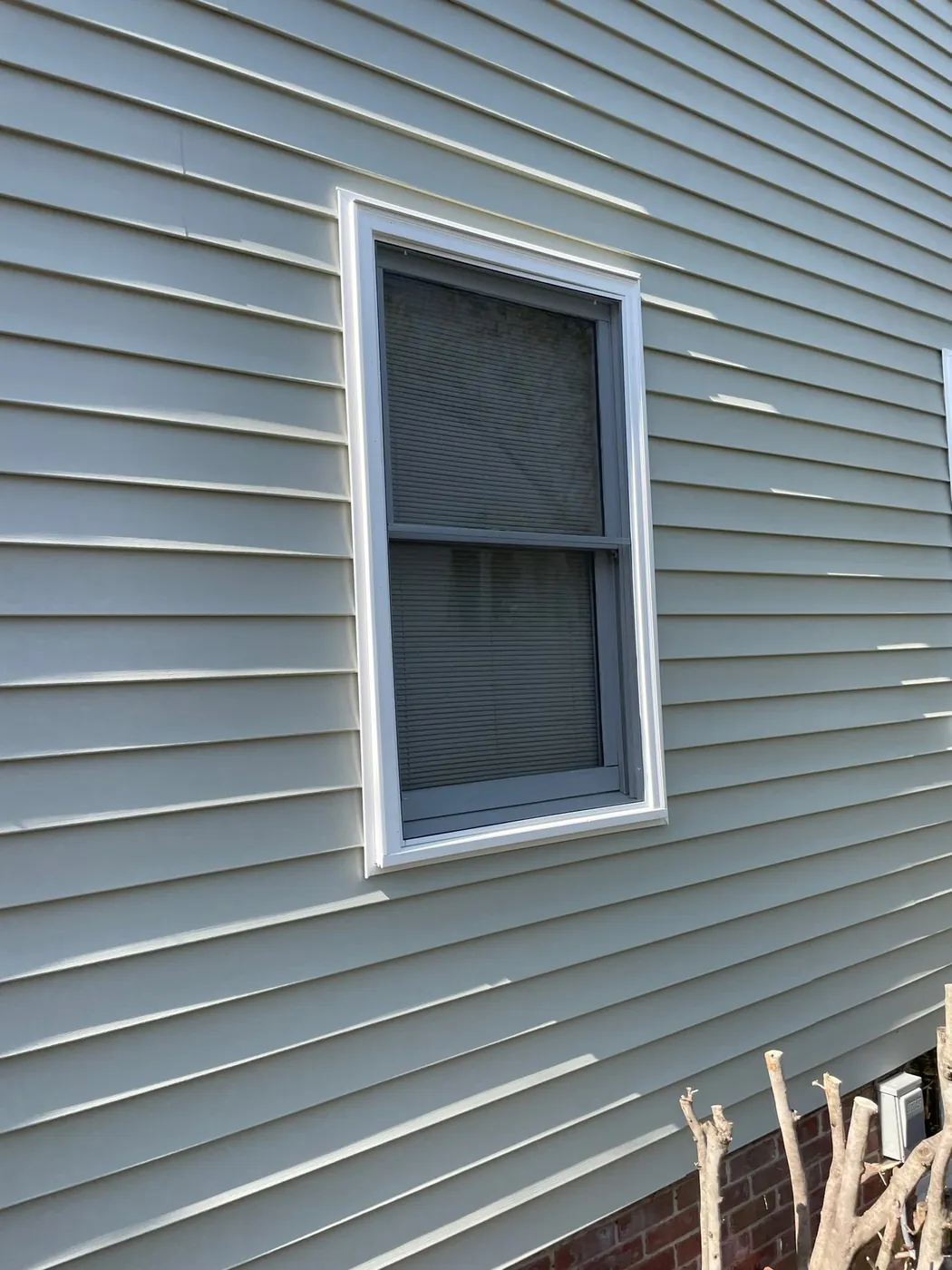 Half window screen fitted to the lower operable sash of a residential window.