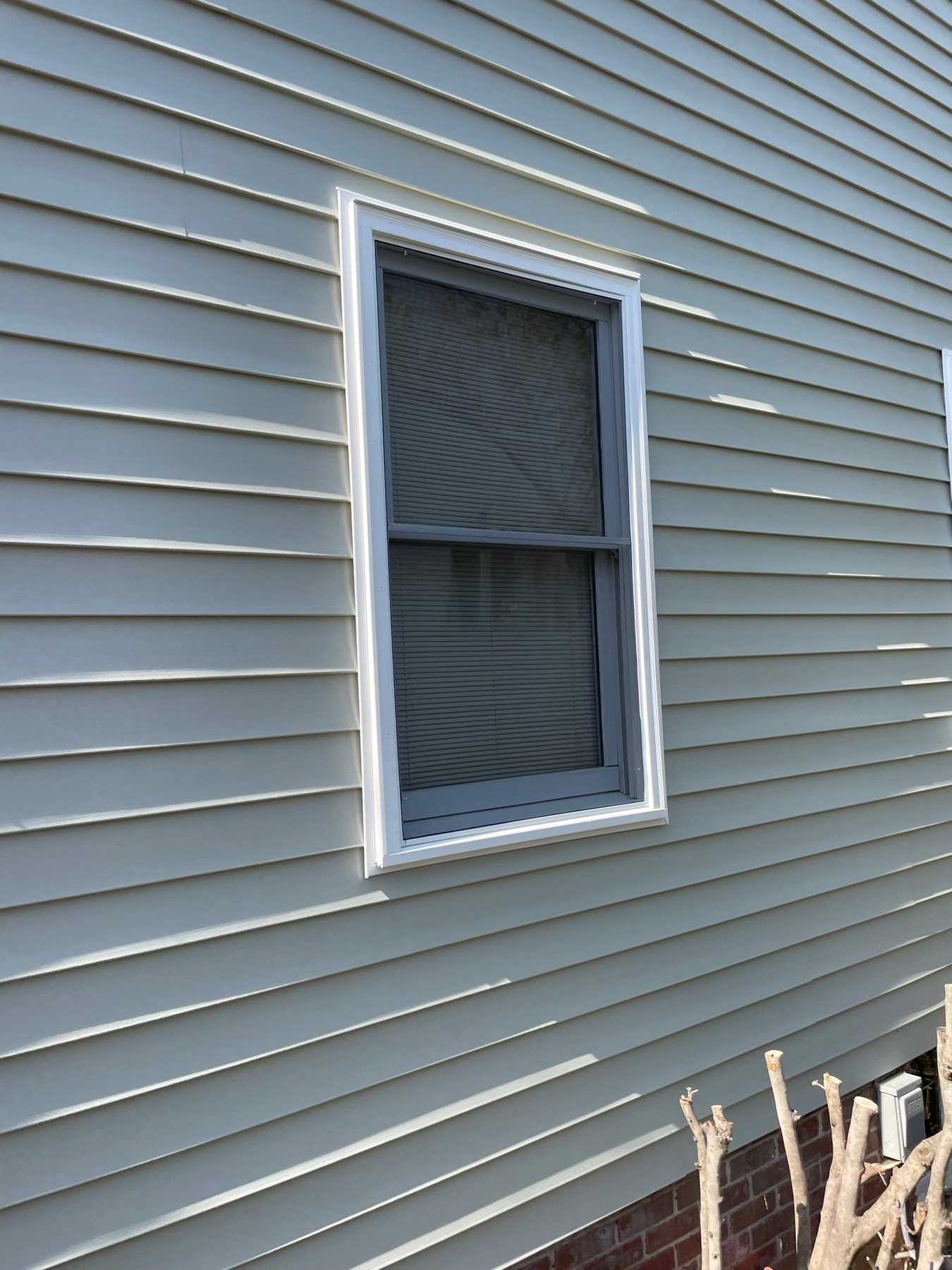 Half window screen fitted to the lower operable sash of a residential window.