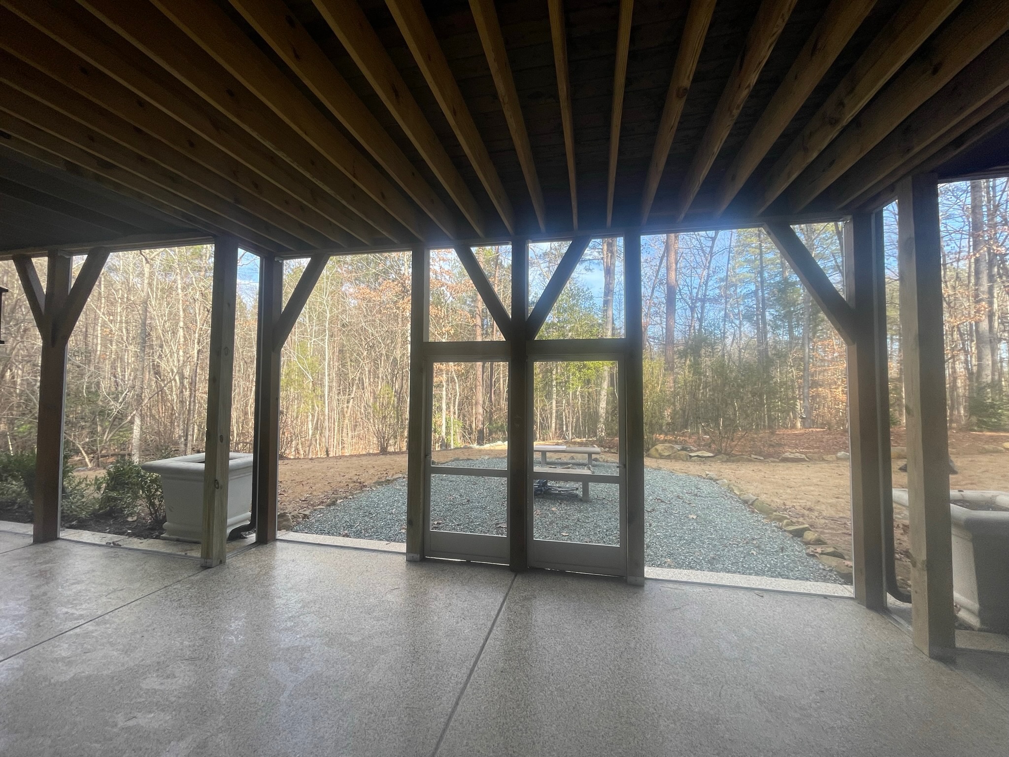 BetterVue screen mesh installed with a white ScreenEZE system, preserving a clear outward view from the porch.