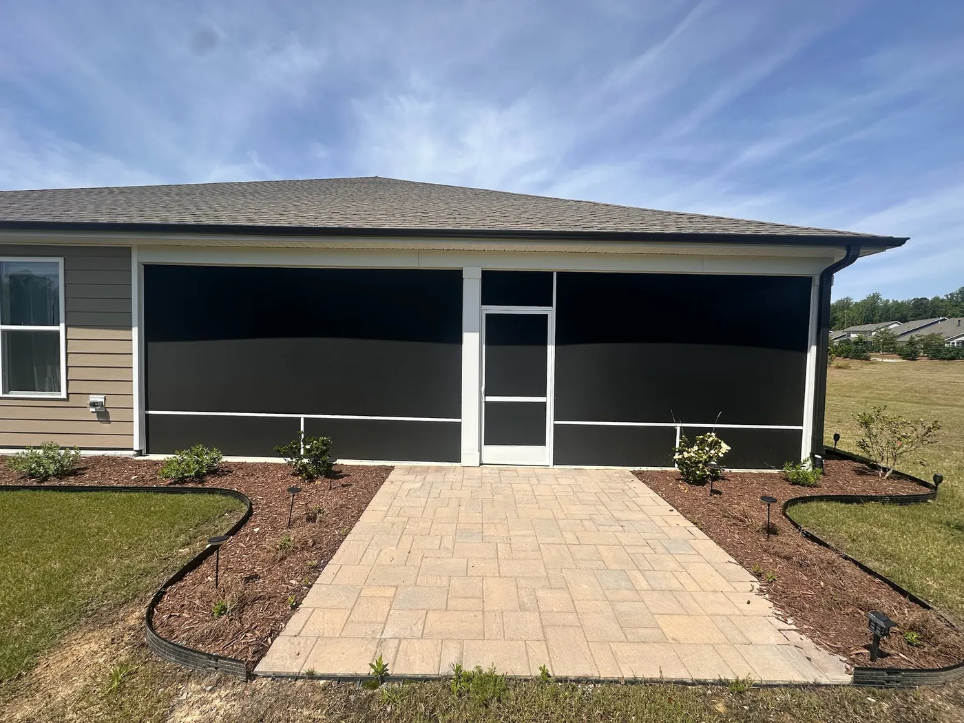 SunTex 90 solar-control screen mesh installed in a white extruded-aluminum porch enclosure.