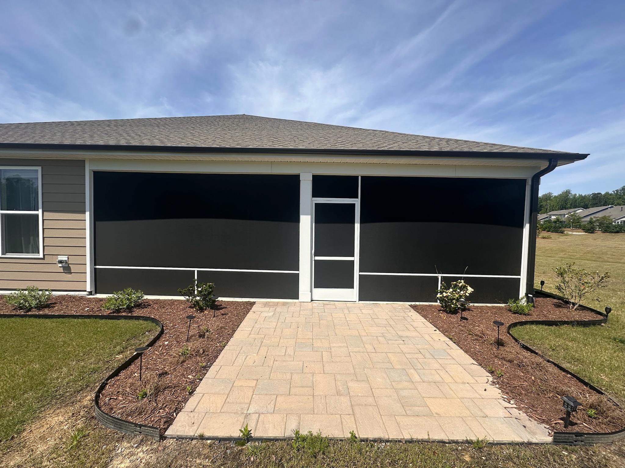 SunTex 90 solar-control screen mesh installed in a white extruded-aluminum porch enclosure.